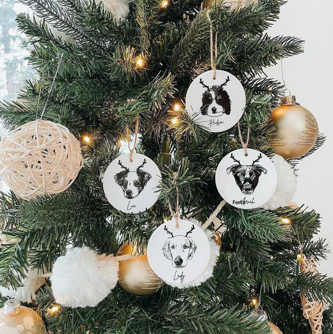 Full view of personalized ceramic pet ornaments hanging on a Christmas tree; one ornament per order